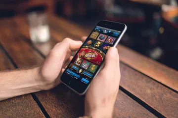 A cheerful woman in traditional clothing using her smartphone during a festive moment, showing how easily the JL66 app fits into everyday life.